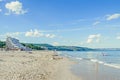 The Black Sea shore with hotels, beach with blue clear water and sand, sky with fluffy clouds