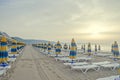 The Black Sea shore at sunrise, beach sand with umbrellas Royalty Free Stock Photo