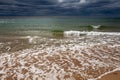 Black Sea. Water with waves. Dark cloudy weather. Deep bright blue water. Before storm. Sand coast Royalty Free Stock Photo