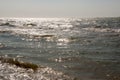 Black Sea. Water with waves. Mainly cloudy weather and sun rays. Blue and grey clouds. Before rain. Sand coast Royalty Free Stock Photo