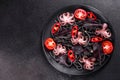 Black seafood pasta with shrimp, octopus and mussels on black background. Mediterranean gourmet food Royalty Free Stock Photo