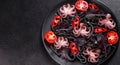 Black seafood pasta with shrimp, octopus and mussels on black background. Mediterranean gourmet food Royalty Free Stock Photo