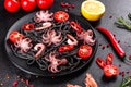 Black seafood pasta with shrimp, octopus and mussels on black background. Mediterranean gourmet food Royalty Free Stock Photo