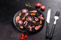 Black seafood pasta with shrimp, octopus and mussels on black background. Mediterranean gourmet food Royalty Free Stock Photo