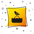 Black Seagull sits on a buoy in the sea icon isolated on white background. Yellow square button. Vector Royalty Free Stock Photo