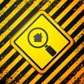 Black Search house icon isolated on yellow background. Real estate symbol of a house under magnifying glass. Warning