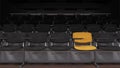 Black Seats with a Single Yellow One Inside a Lecture Room in Dim Light