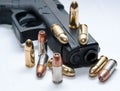 A black semiautomatic 9mm pistol with ten bullets on and around it Royalty Free Stock Photo