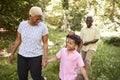 Black senior couple walking in forest with grandchildren Royalty Free Stock Photo