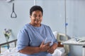 Black senior woman sitting on bed in hospital room with oxygen cannulas Royalty Free Stock Photo