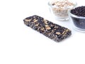 Black sesame and whole grain cereal bar with glass bowl isolated Royalty Free Stock Photo