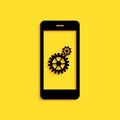 Black Setting on smartphone screen icon isolated on yellow background. Mobile and gear. Adjusting app, set options