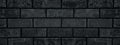 Black shabby brick wall close-up wide texture. Dark gray brickwork grunge widescreen background