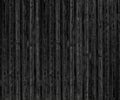 Black shabby wooden board texture. Rough old knotted wood surface. Dark gloomy grunge background Royalty Free Stock Photo
