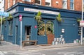 The Black Sheep pub in Dublin with beer kegs outside and windows painted with Irish motifs.