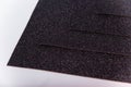 Black Sheets of cardboard with sparkles on a white background Royalty Free Stock Photo