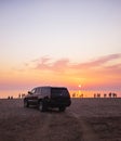 Cadillac Escalade on sunset beach