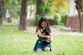 A black Shiba Inu dog and girl in a park