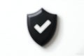 Black Shield with Check Mark on White Background Royalty Free Stock Photo