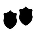 Two simple black shield silhouettes are displayed on a plain white background Royalty Free Stock Photo
