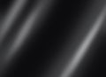 Black shiny metal plate dark soft background. Soft blurry spotlights on black background