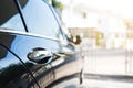 Black shiny surface of luxury modern car side view, selective focus Royalty Free Stock Photo