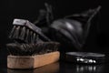 Black shoe polish, brush and shoes on the table. Accessories for cleaning leather footwear Royalty Free Stock Photo