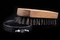 Black shoe polish, brush and shoes on the table. Accessories for cleaning leather footwear Royalty Free Stock Photo