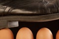 Black shoe walking on brown eggs Royalty Free Stock Photo