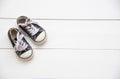 Black shoes for children on wooden floor