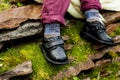 Black shoes with colored socks on child legs Royalty Free Stock Photo