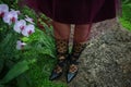 Black shoes and female legs on a green background