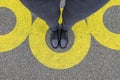 Black shoes standing in yellow circle on the asphalt concrete floor. Comfort zone or frame concept. Feet standing inside comfort Royalty Free Stock Photo