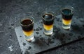 Black Shooter - Black Balsam and peach juice. Hard alcoholic shots on stone table