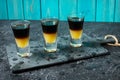 Black Shooter - Black Balsam and peach juice. Hard alcoholic shots on stone table