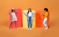 Black shopaholics women posing by giant shopping bags, studio, collage