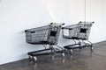 Black shopping Cart on the floor and white background. trolley is a cart supplied by a shop, especially supermarkets.