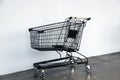 Black shopping Cart on the floor and white background. trolley is a cart supplied by a shop.