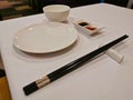 Black shopsticks and white Chinese eating utensil eating equipments in Yum Cha restaurant