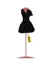 Black short female dress on a pink mannequin and tag sale isolated on a white background Royalty Free Stock Photo