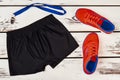 Black shorts, orange sneakers, whistle