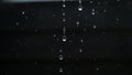 Black Background with Multiple Clear Water Droplets Falling and Scattered in Motion Royalty Free Stock Photo