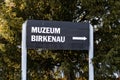 Black sign to the Museum Birkenau in front of Auschwitz in Oswiecim, Poland