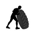 Black silhouette of athletic men carring big heavy tyre