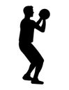 Black silhouette of a basketball player who stands and holds the ball with both hands to make a set shot and shoot ball into the Royalty Free Stock Photo