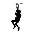 Black silhouette of a girl coming down on zip-line Royalty Free Stock Photo