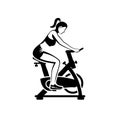 Black silhouette girl on an exercise bike. Beautiful athletic girl doing fitness.