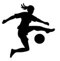 Black silhouette of a girl in a sports uniform playing football jumpimg high to kick the ball