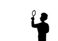 Black silhouette isolated young business man detective seeker with magnifying glass in white background. Monochrome. Copy space.