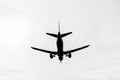 Black silhouette of a landing plane Royalty Free Stock Photo